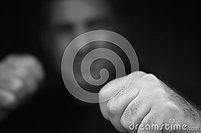 Abusive aggressive man punching fists Stock Photo