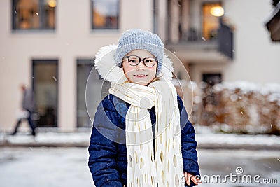 Portrait of adorable little girl outdoors on cold winter day. Cute preschool child in warm clothes, with knitted hat and Stock Photo