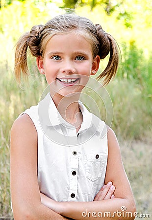 Portrait of adorable smiling little girl child in dress outdoor Stock Photo