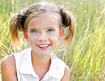 Portrait of adorable smiling little girl child in dress outdoor Stock Photo