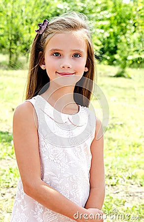 Portrait of adorable smiling little girl child outdoors Stock Photo