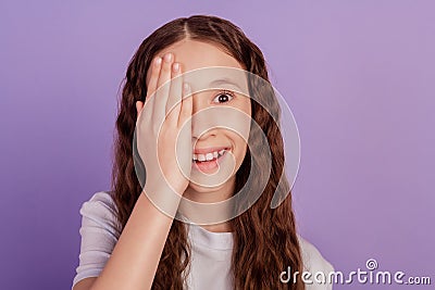 Portrait of adorable sweet small lady palm close half face look camera eye examination on purple background Stock Photo