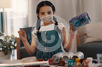 Its time to add a bit of color. Portrait of an adorable young painting and building a toy robot at home. Stock Photo