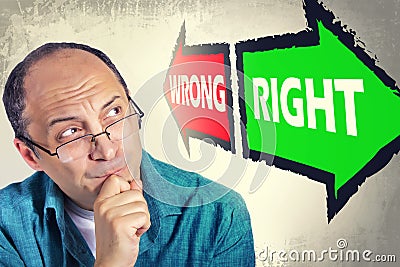 Portrait of adult man faced with choice between RIGHT and WRONG Stock Photo