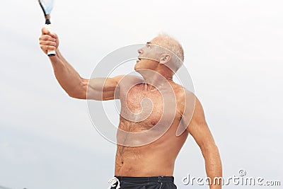Adult male playing matkot on the beach Stock Photo