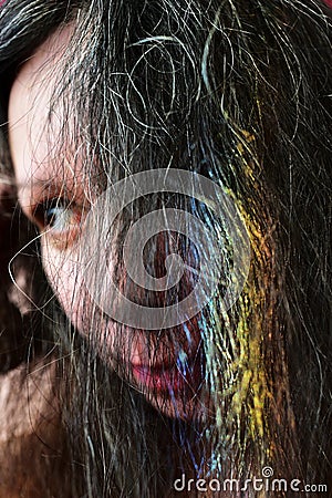 Portrait af a young woman with a rainbow on dark hair Stock Photo