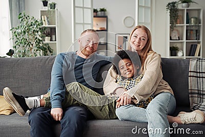Happy adoptive boy with his parents Stock Photo