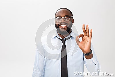 Portrait of african american business man smiling and showing okay sign. Body language concept Stock Photo