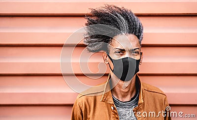 Portrait of african american guy wearing black protective face mask - New normal lifestyle concept with young man Stock Photo