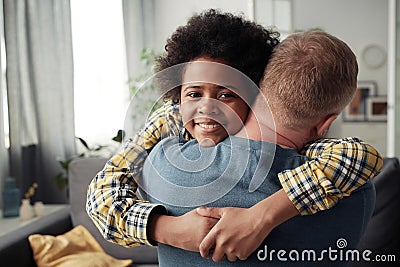 Adoptive boy embracing his foster dad Stock Photo