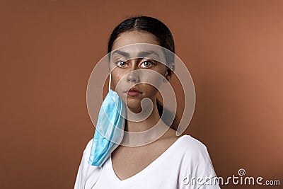 Portrait of an African woman with hypertrophied facial features, wearing a mask. Brown background. Unreal portrait, like Stock Photo