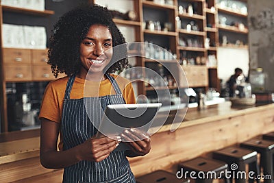 Portrait of an african young female cafe owner Stock Photo