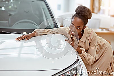 Portrait of africanamerican woman hugging new auto Stock Photo