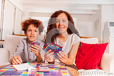 Brother and sister playing card games indoors Stock Photo