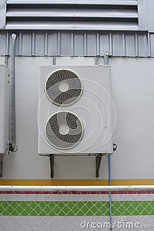 Portrait of air conditioner units on wall outside building Stock Photo