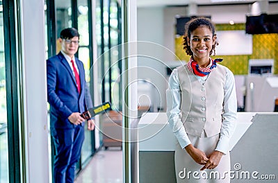 Portrait of air hostess and airline staff at gate of airport to welcome and check the security of passenger before go inside of Stock Photo