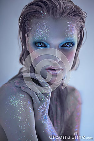 Portrait of alien woman with glitter make up Stock Photo