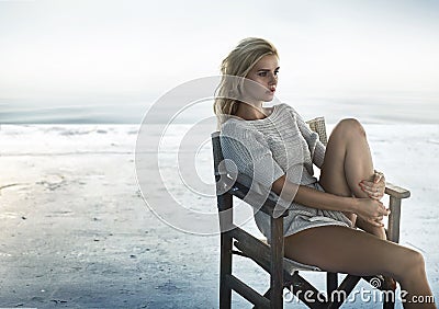 Portrait of an alluring woman sitting on the retro chair Stock Photo