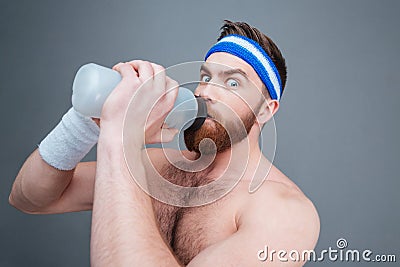 Portrait amazed bearded sportsman drinking water Stock Photo