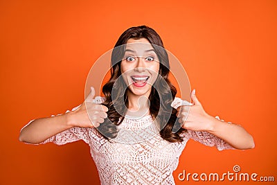 Portrait of amazed excited girl advertise show thumb-up sign suggest select promo wear knitted blouse isolated over Stock Photo