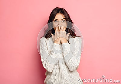 Portrait of amazed young woman over pink background Stock Photo