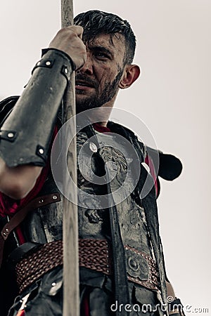 Portrait of ancient Spartan warrior in armor with spear Stock Photo