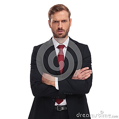 Portrait of angry businessman with folded arms standing Stock Photo