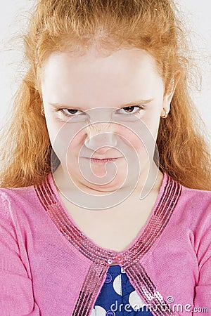 Portrait of Angry and Furious Little Caucasian Redhaired Girl Stock Photo