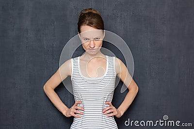 Portrait of angry girl looking disapprovingly from under forehead Stock Photo