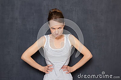 Portrait of angry girl looking disapprovingly from under forehead Stock Photo