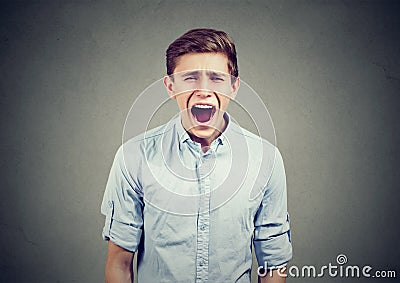 Portrait of an angry young man screaming Stock Photo