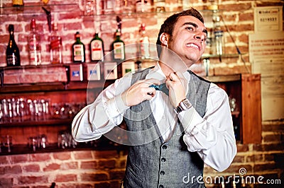 Portrait of angry and stressed bartender or barman with bowtie Stock Photo