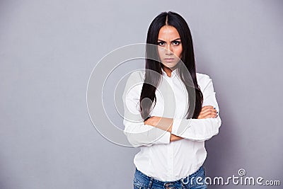 Portrait of angry woman standing with arms folded Stock Photo