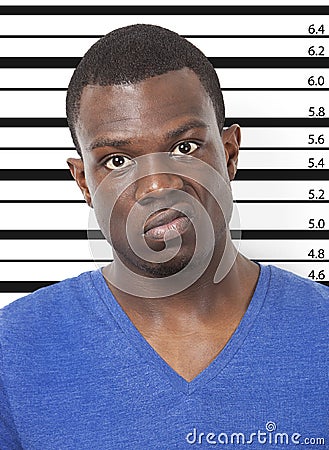 Portrait of angry young African American man against height chart Stock Photo