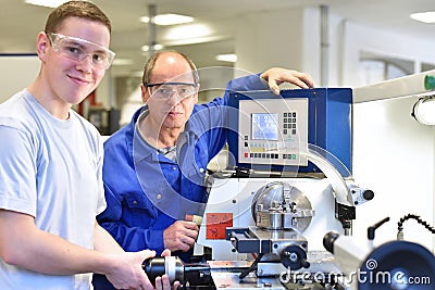 Portrait apprentice and teacher in vocational training at a cnc Stock Photo