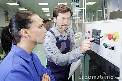 portrait apprentice working with engineer on cnc machine Stock Photo