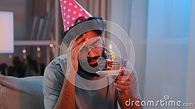 Portrait Arabian sad upset lonely Indian bearded man celebrate birthday alone without friends feel sadness headache Stock Photo