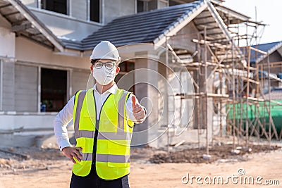 Portrait of Architect wearing a mask reassure on a building construction site, Homebuilding Ideas and Prevention of Coronavirus Stock Photo