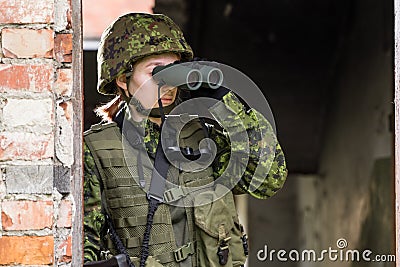 Portrait of armed woman with camouflage Stock Photo