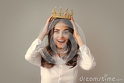 Portrait of arrogance woman with golden crown on head, leadership and success. Attractive rich arrogant girl wearing Stock Photo