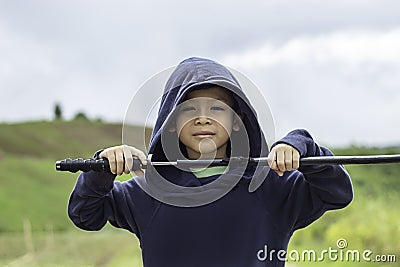 Portrait of Asean boy holding a wooden sword play Stock Photo