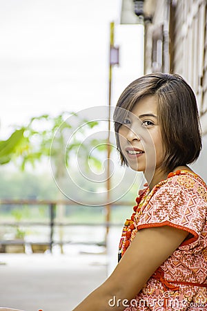 Portrait of Asean woman wearing a native of northern Thailand background wooden wall Stock Photo