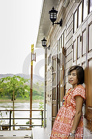 Portrait of Asean woman wearing a native of northern Thailand background wooden wall Stock Photo