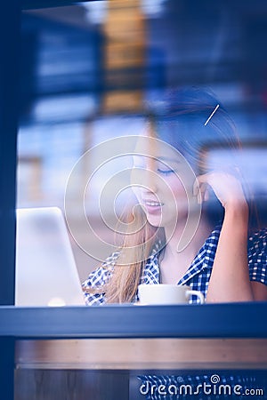 Portrait asia young woman working on laptop in coffee shop Stock Photo