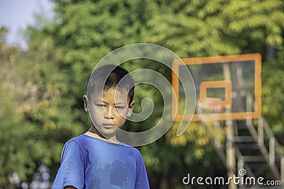 Portrait of Asian boy Sweating face Background on basketball court Stock Photo