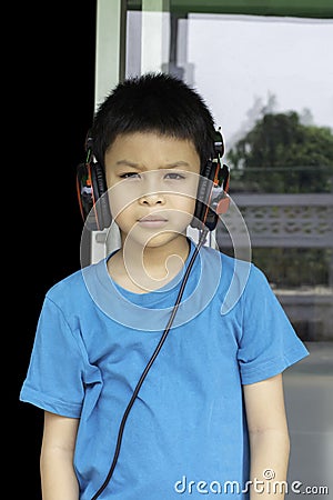 Portrait of Asian boy wearing headphones Background blurry Stock Photo