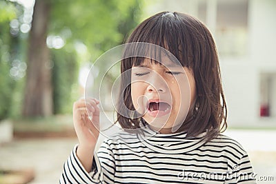 Portrait of Asian crying little girl with little rolling tears weeping emotion, hurt in pain fit drops cheek. Young crying panic Stock Photo