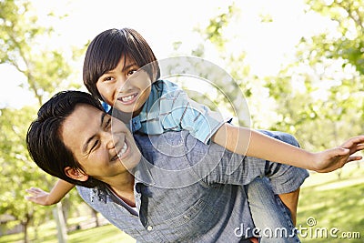 Portrait Asian father and son playing in park Stock Photo