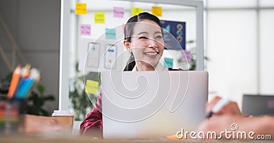 Portrait of asian female leader smiling when meeting with ux developer and ui designer about mobile app interface wireframe design Stock Photo