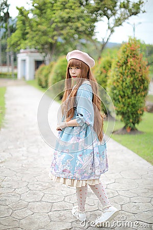 Portrait of asian girl in lolita fashion dress in garden Stock Photo